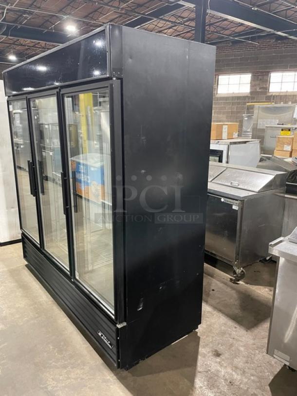 True Commercial Black Triple Glass Door Refrigerator, Model GDM-72, with poly-coated wire racks, in used condition.
