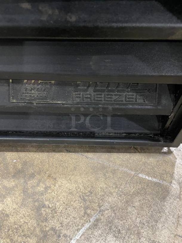 True Commercial Triple Glass Door Freezer, Model GDM72F, black, poly-coated wire racks, visible logo plate.