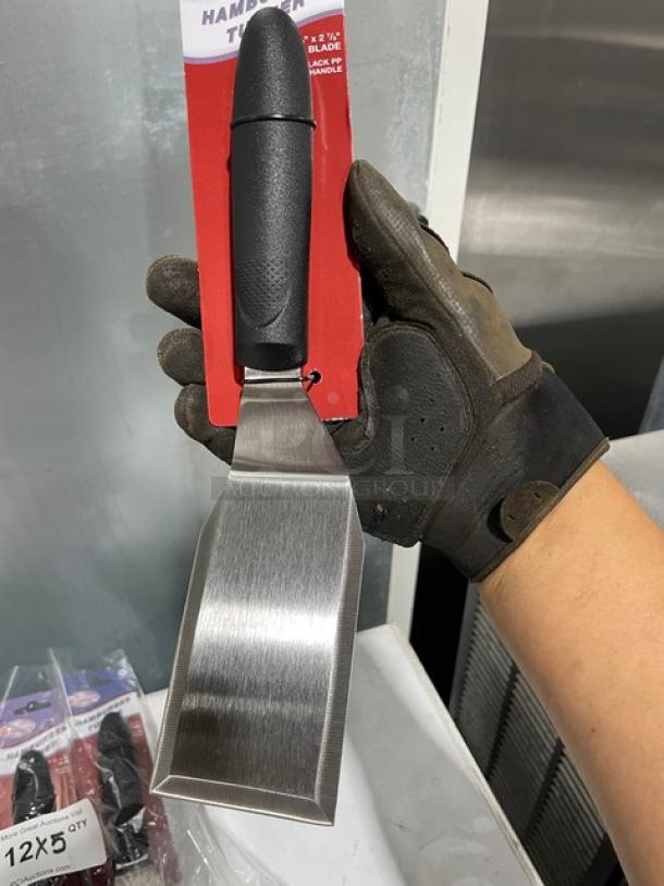 Winco TKP-61 stainless steel offset hamburger turner, new, with black grip handle; model label shown.