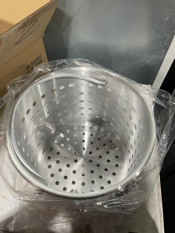New Winco 20 Qt. perforated aluminum steamer basket with pail handle, model ALSB-20, wrapped in plastic.