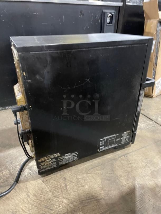 MerryChef Eikon E2S high-speed countertop oven, black, electric, 208/240V, 1 phase, shows some wear, visible labels with specs.