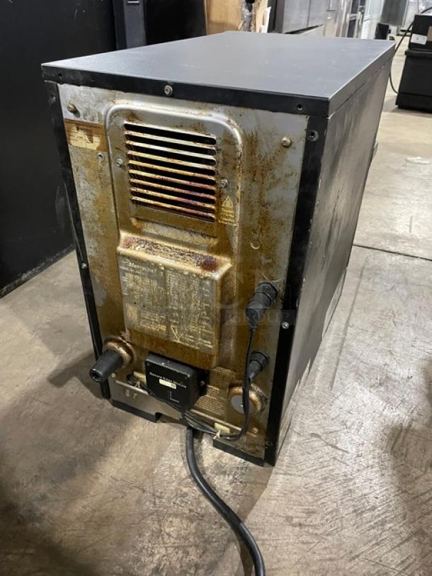 MerryChef Eikon E2S commercial black high-speed electric oven, 208/240V, showing back panel with power cord attached. Signs of use visible.