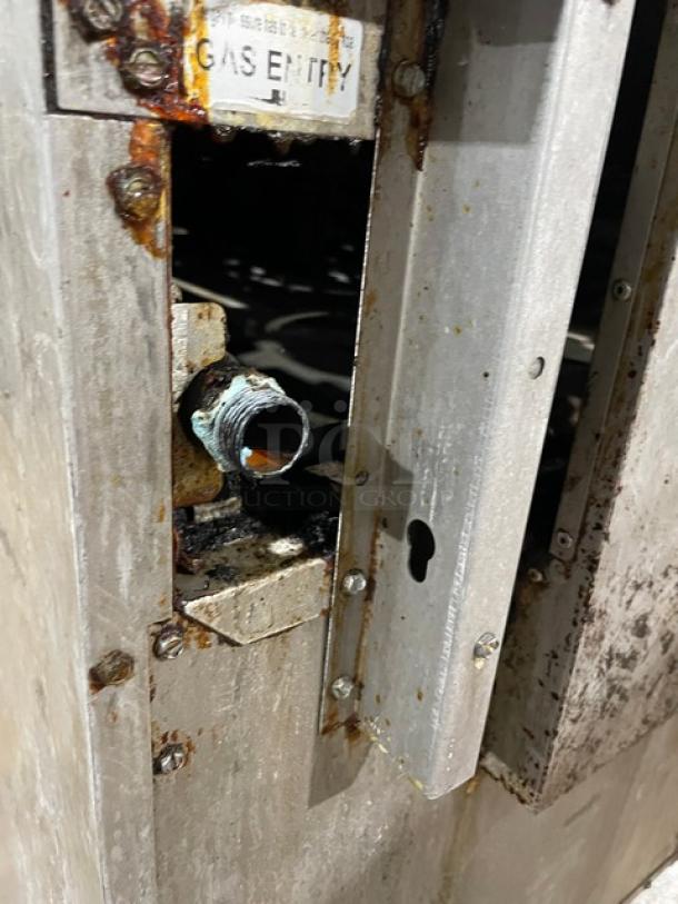 CPG Stainless Steel 4 Burner Range/Oven Gas Inlet. Signs of rust and wear visible. Model: 351S24N. Auction item detail.