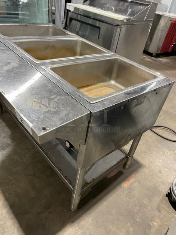 Eagle Group stainless steel gas-powered 3-pan hot food/steam table with tray slide and single undershelf on legs. Used condition.