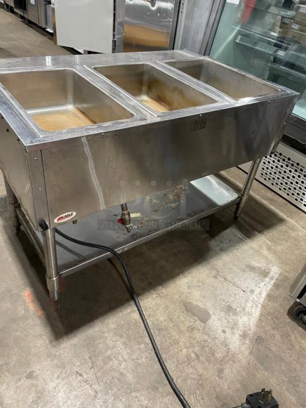 Eagle Group stainless steel gas-powered 3-pan steam table with tray slide, single undershelf, on legs, used condition.