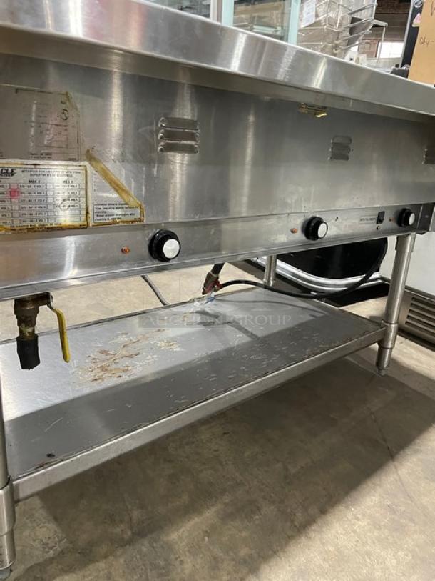 Eagle Group stainless steel gas-powered 3-pan steam table with tray slide, single undershelf, and legs, showing control knobs.