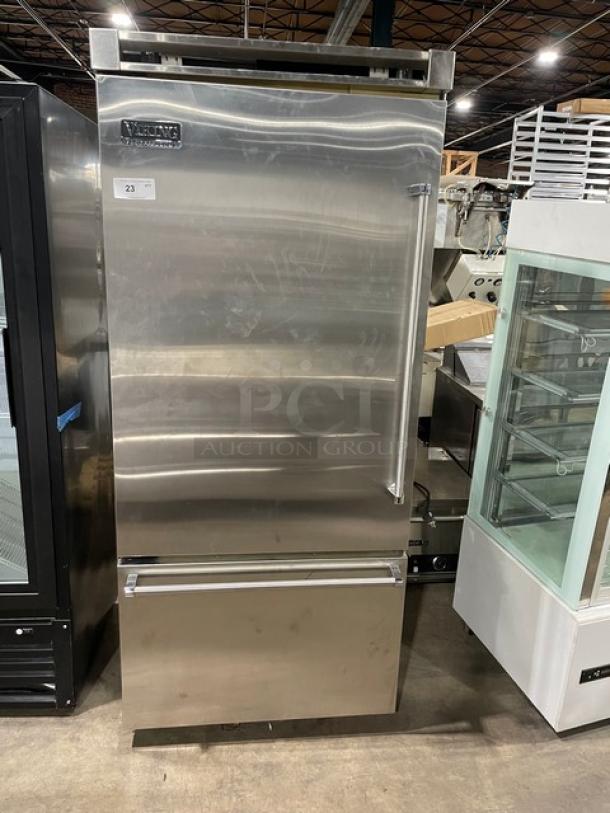 Viking Professional stainless steel fridge-freezer combo with single door, drawer, adjustable shelves, and wire basket; model label visible.