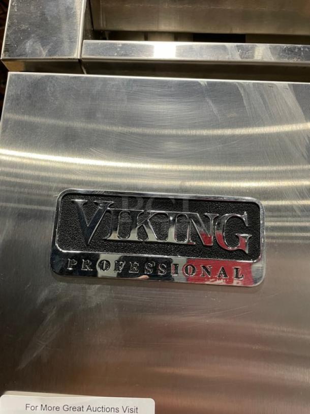 Viking Professional stainless steel refrigerator freezer combo with adjustable shelves and wire basket. Solid door, excellent condition.