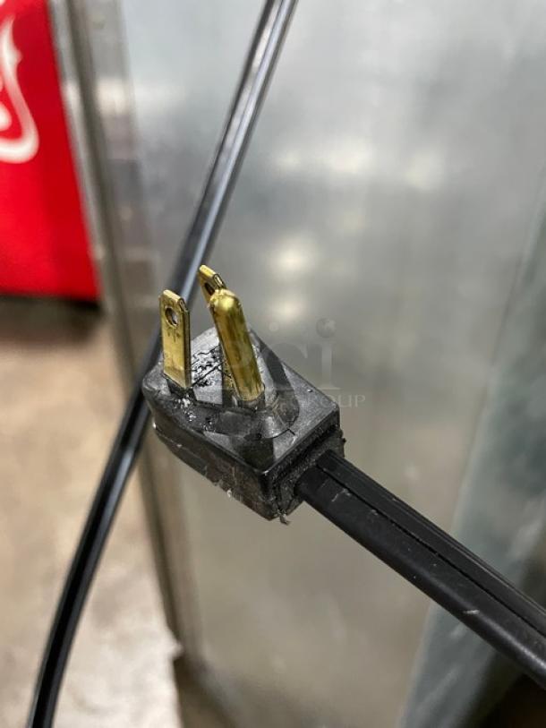 Close-up of power plug for Viking Professional Series refrigerator freezer combo. Visible metal prongs, black casing.