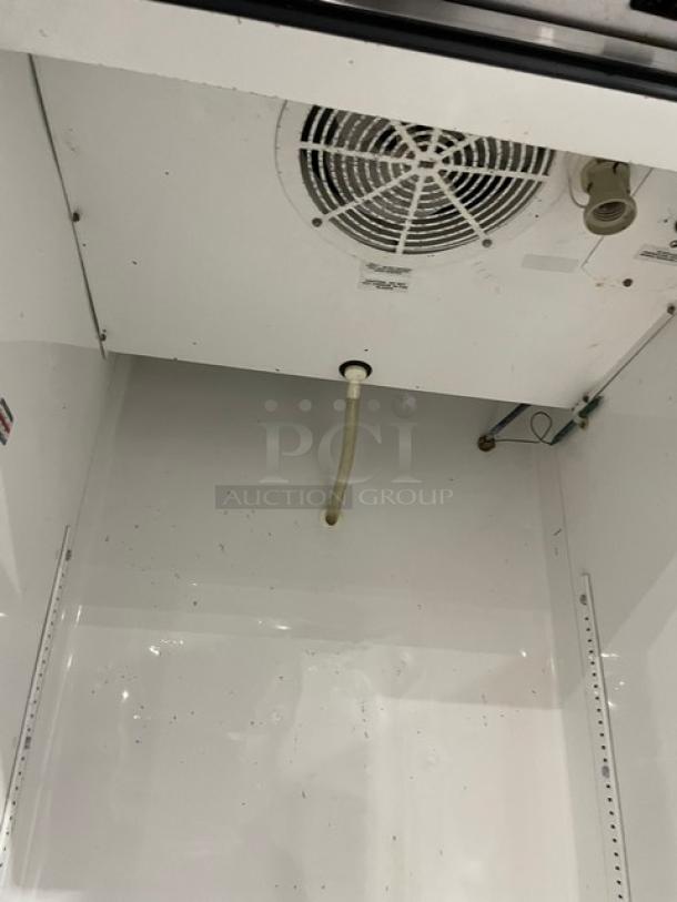 True T-23 commercial stainless steel reach-in refrigerator interior. Features adjustable shelving, fan, and drainage. Energy Star certified.
