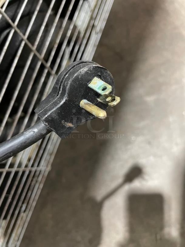 Close-up of a power plug for the Imbera VRD43 commercial refrigerator. Visible poly coated wire rack detail.