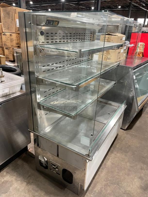 Commercial stainless steel refrigerated multi-tier display case with straight glass, adjustable shelves, and open front.