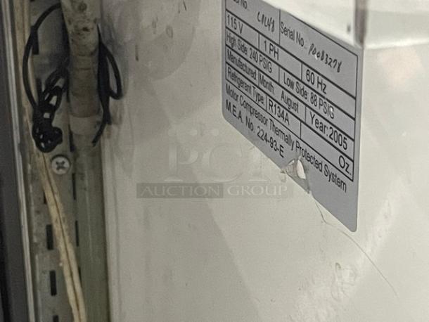 Leader CDL48 refrigerated display showcase, stainless steel, slanted glass, rear access doors, model and serial label shown.