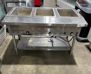 Eagle Group stainless steel gas-powered hot food table, 3-pan, with tray slide and single undershelf. On legs, used condition.