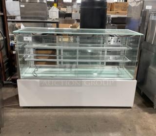 Commercial white refrigerated bakery display case with straight glass, multi-tier shelving, and rear double sliding glass doors.