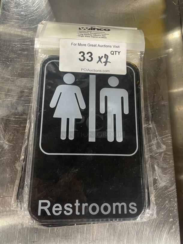 Winco SGN-603 commercial black "Restrooms" sign, new in packaging, featuring male and female symbols.