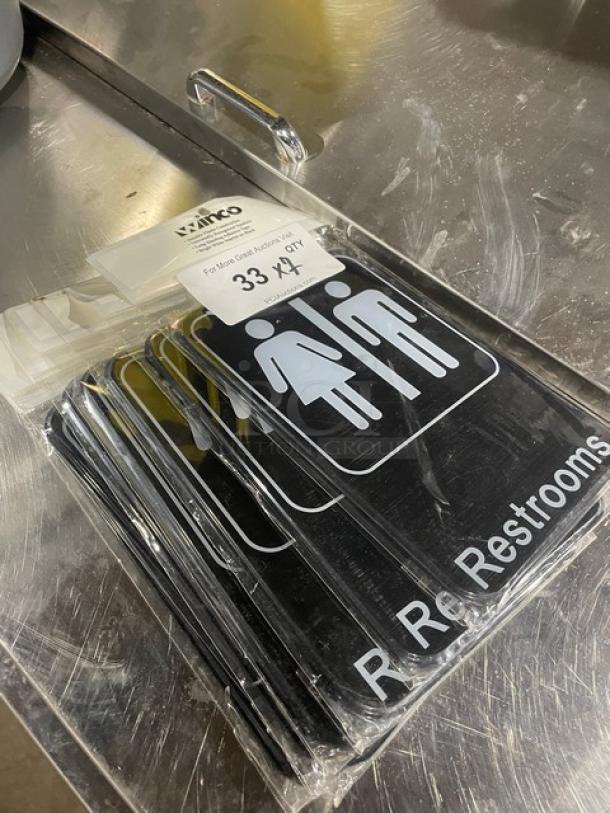 NEW Winco SGN-603 black restrooms sign, commercial use, 7-pack. Dimensions 7" x 6". Durable material, clear labeling.