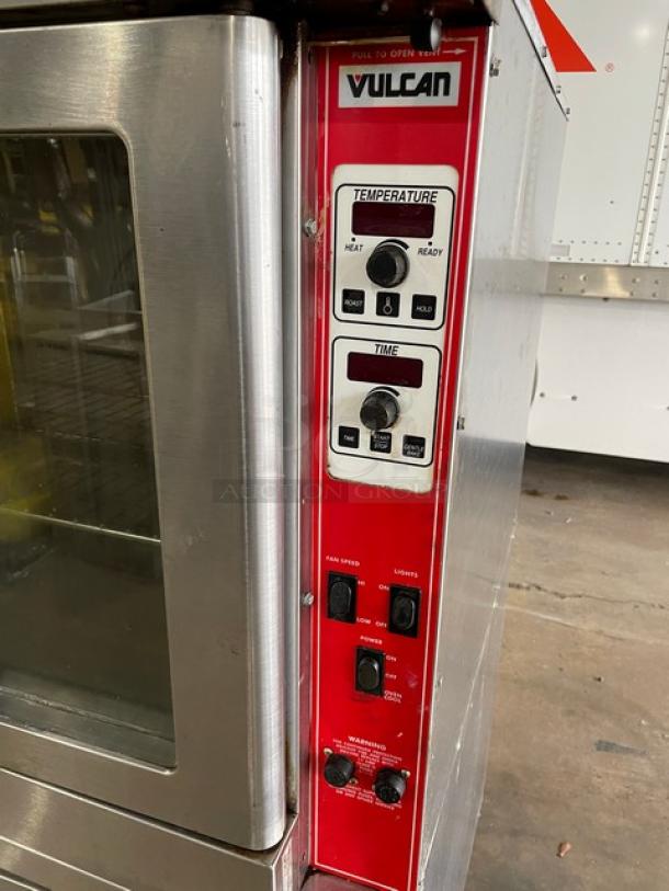 Vulcan commercial stainless steel double-stacked convection oven with electric controls, wired racks, on casters.