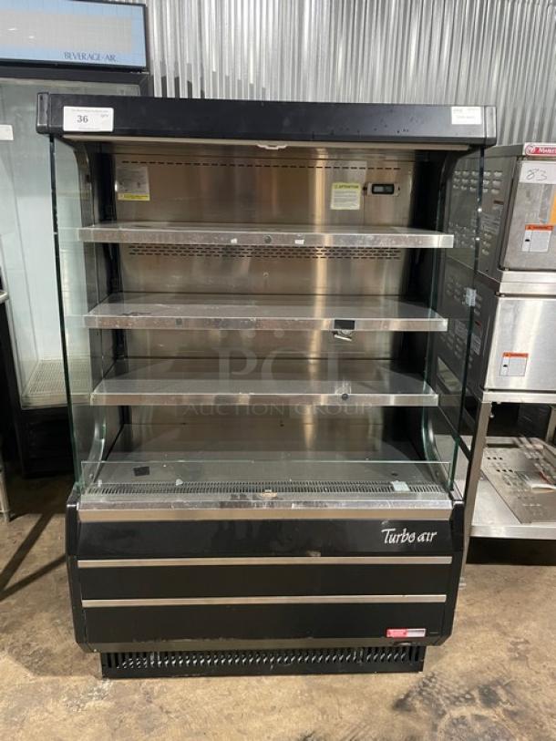 Turbo Air TOM-40MB black air-curtained refrigerated merchandiser with stainless steel interior and shelves, 120V 1 Phase.