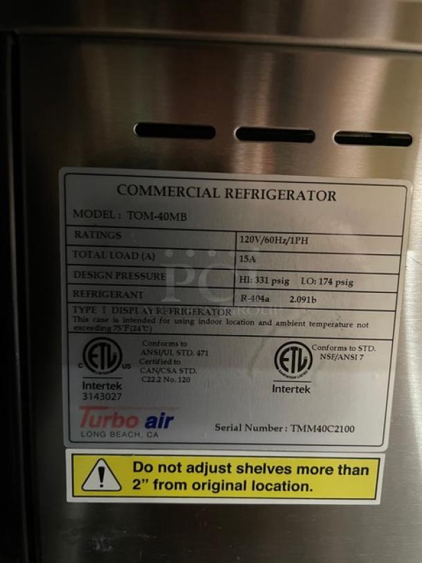 Turbo Air refrigerated display case label showing model TOM-40MB, 120V, with specs on pressure and refrigerant.