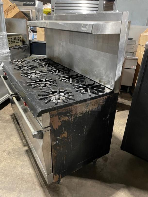 Vulcan commercial stainless steel 10-burner range with double oven, backsplash, overhead salamander shelf, and wired oven racks.