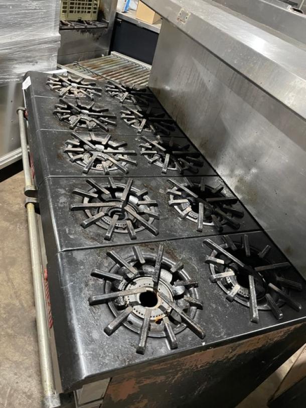 Vulcan commercial stainless steel 10-burner range/double oven combo with back splash and overhead salamander shelf.
