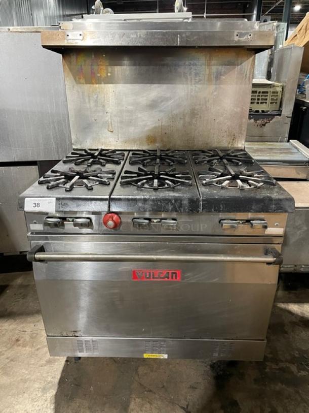 Vulcan commercial stainless steel 6-burner natural gas range/oven combo with backsplash, overhead salamander shelf, and wired oven rack.