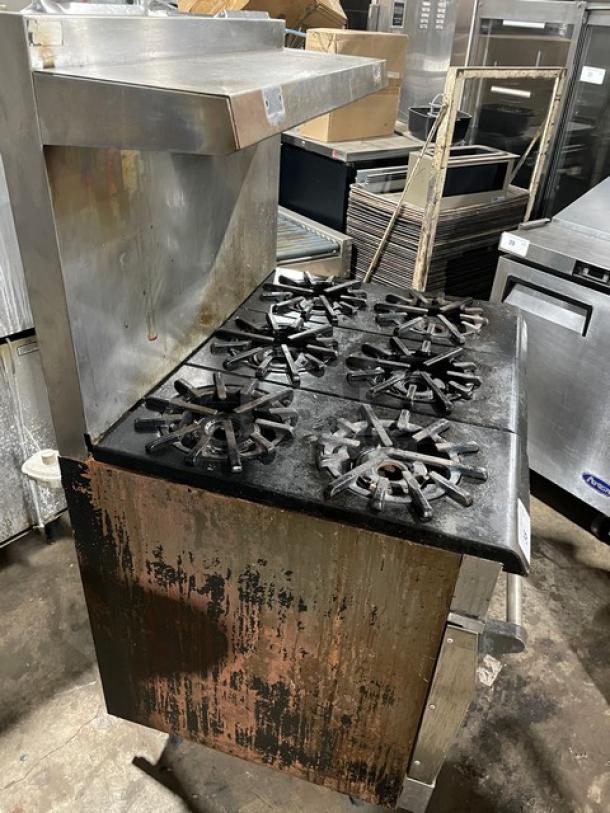 Vulcan commercial stainless steel 6-burner range/oven combo, natural gas, with backsplash, overhead salamander shelf, and wired rack.