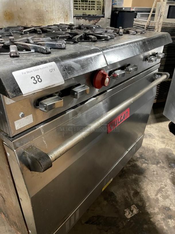 Vulcan commercial stainless steel 6-burner range/oven, natural gas, with backsplash, salamander shelf, and wired oven rack.