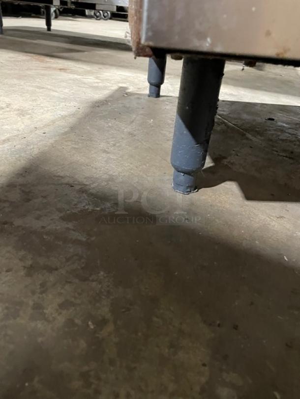 Vulcan commercial 6-burner range/oven combo leg close-up, showing sturdy construction on legs.