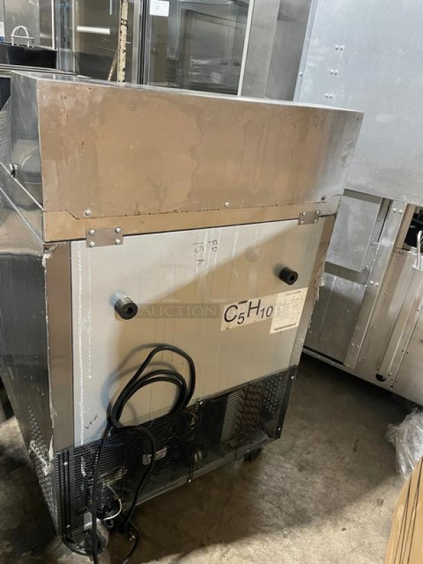 Atosa 2019 stainless steel single-door refrigerated prep table, model MSF8301GR, on casters with wire rack.