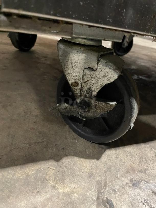 Atosa MSF8301GR single door refrigerated prep table caster wheel, showing wear. Model 2019, on casters for mobility.