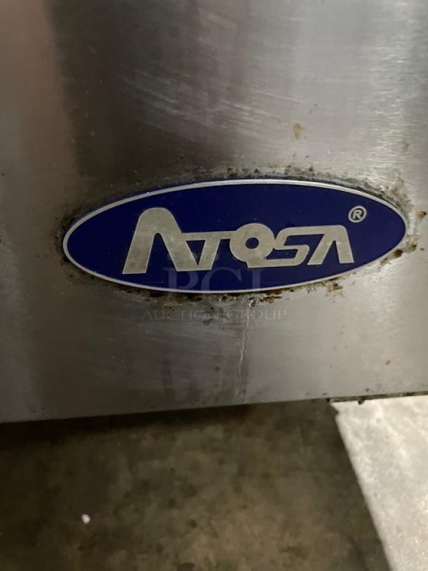 Atosa logo on stainless steel surface of 2019 commercial refrigerated prep table, Model MSF8301GR, with some wear.