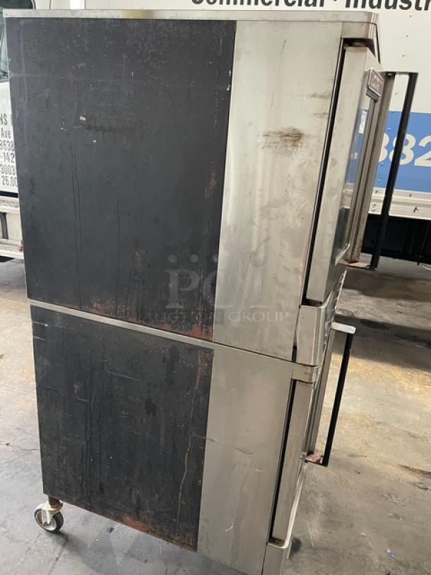 Blodgett double-stacked convection oven, stainless steel, natural gas powered, wired racks, on casters, fair condition.