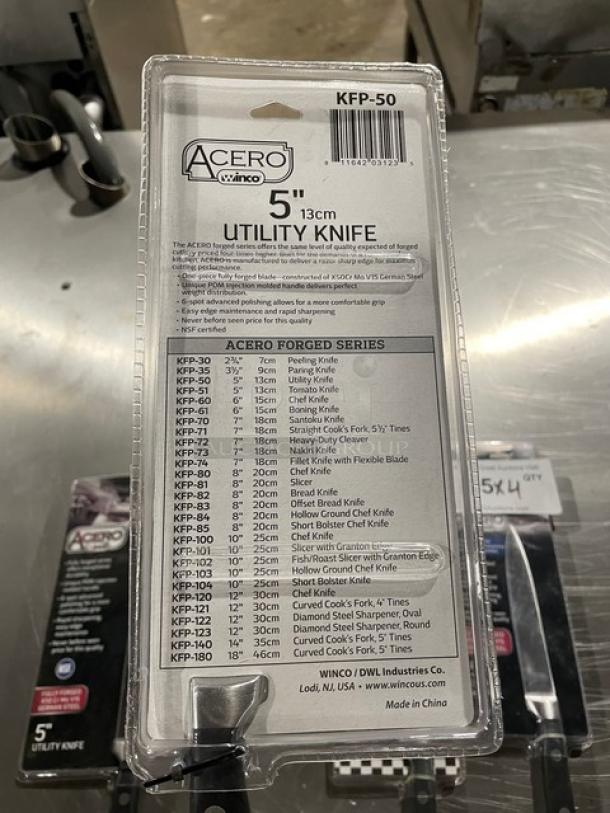 Winco Acero Series 5" Utility Knife, Model KFP-50, with black grip handle. New condition, stainless steel blade, in original packaging.