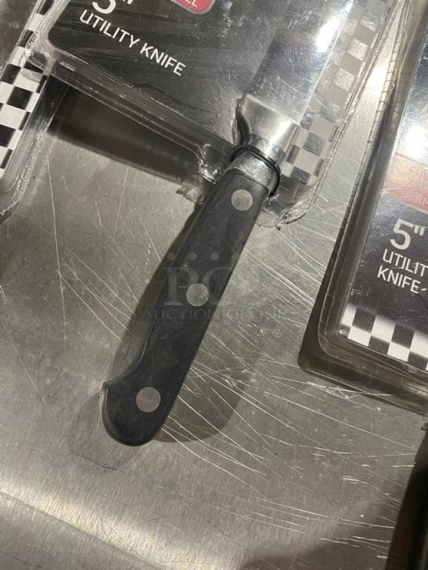 Winco Acero Series 5" utility knife, stainless steel, Model KFP-50, black grip handle, new condition, packaging visible.