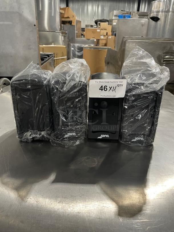 Four new Jofel commercial black napkin dispensers, wrapped in plastic, with visible branding.