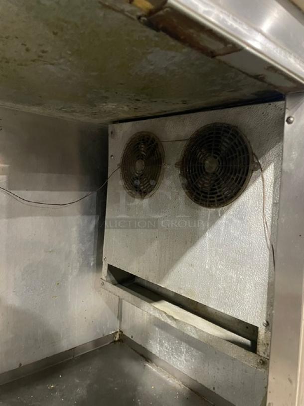 Bari stainless steel 3-door refrigerated pizza prep table with marble style worktop, dual fans, and caster wheels, used condition.