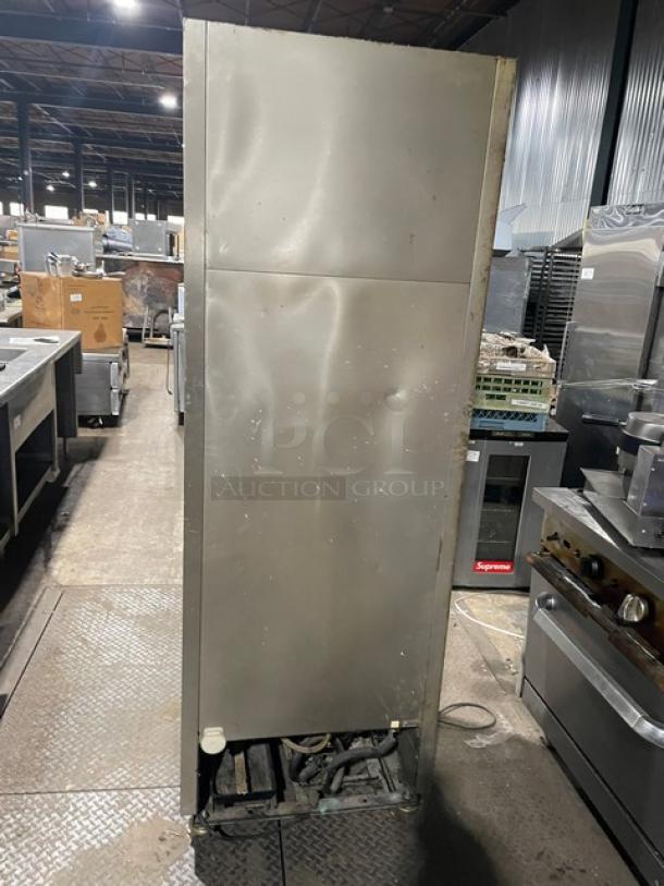 True commercial stainless steel single door reach-in freezer, model T-19FZ. Equipped with poly-coated wire racks, on casters.