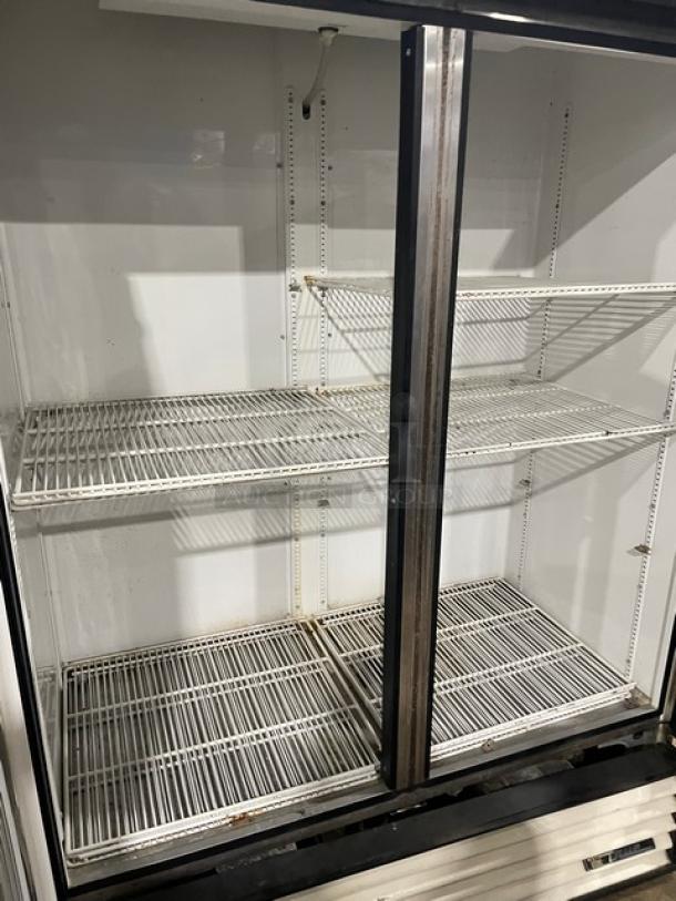 True GDM-49 commercial refrigerator, double glass swing doors, poly-coated wire racks, 115V, used condition.