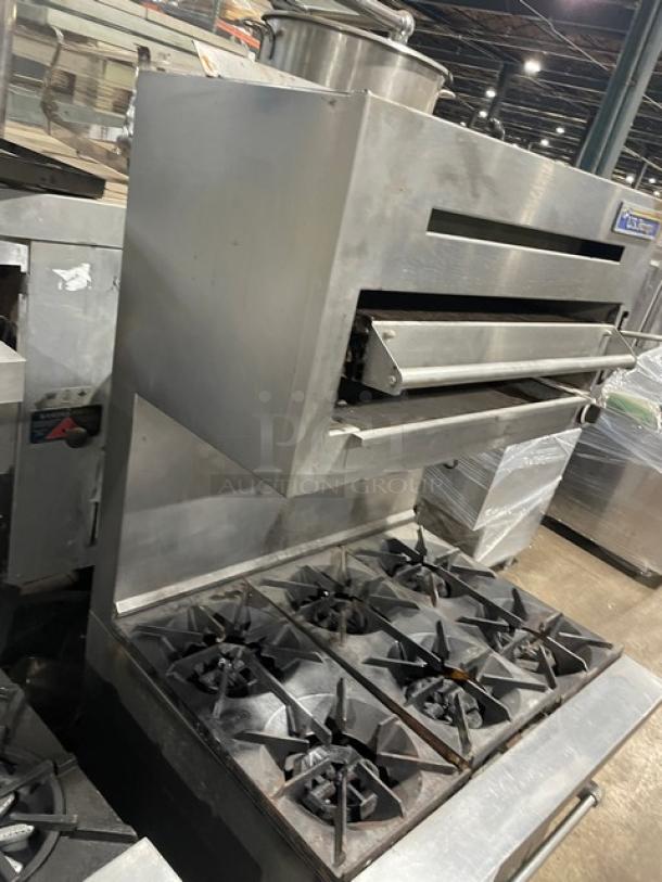 U.S. Range 6-burner stainless steel gas range/oven combo with overhead salamander broiler, wired oven racks, on legs.