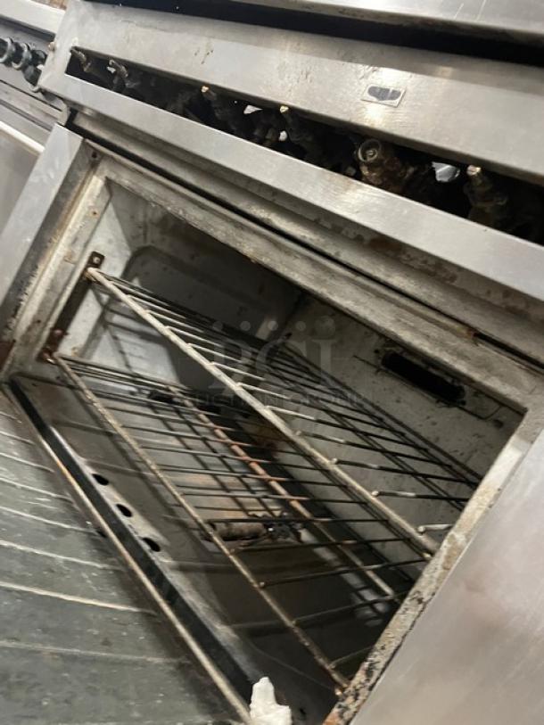 U.S. Range stainless steel 6-burner range/oven combo with overhead salamander broiler, wired oven racks, on legs.