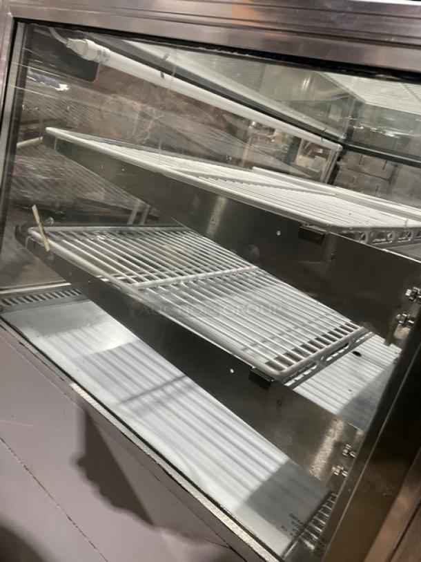 Leader stainless steel refrigerated display case, model CBK57SC. Features straight glass front, 57" wide, adjustable wire racks.