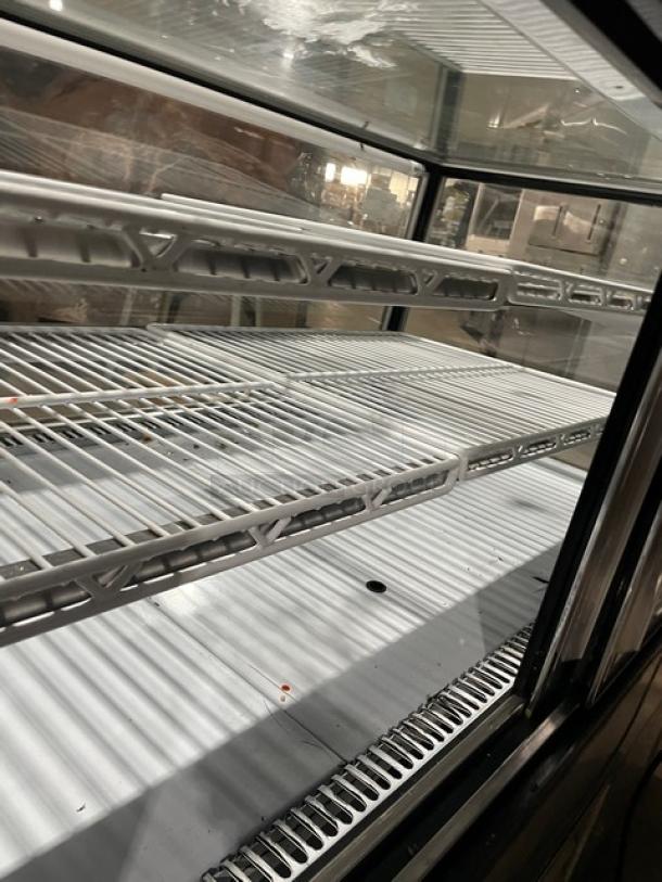 Leader stainless steel refrigerated bakery display case, model CBK57SC. Features adjustable wire racks, 57" wide, used condition.