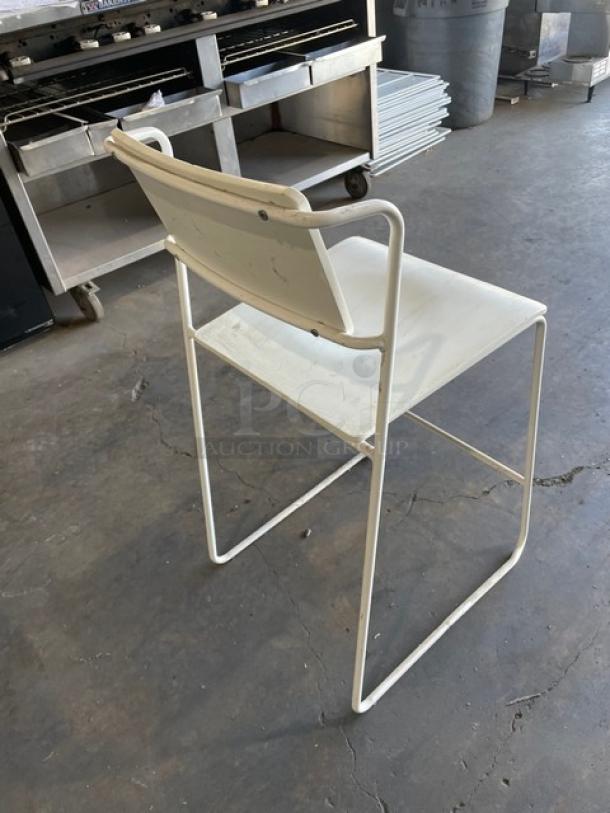 Commercial stackable dining chair, white wooden style seat, metal frame, indoor-outdoor use, good condition.