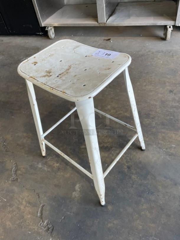 Distressed white metal bar-height stool, stackable, indoor-outdoor, visible wear, labeled lot number "70".