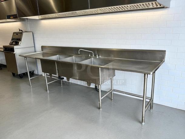 All stainless steel 3 compartment sink in excellent condition, fully tested and working, includes backsplash and drainboard.