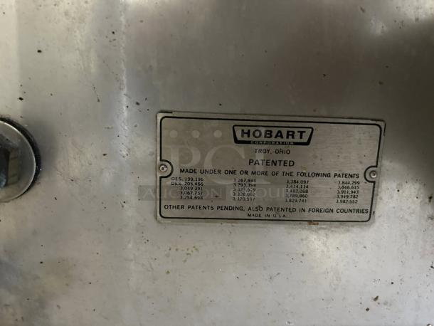 "Metal plate on Hobart AM16-BAS-2 dishwasher showing patent details and 'Made in USA' marking. Slight wear visible."