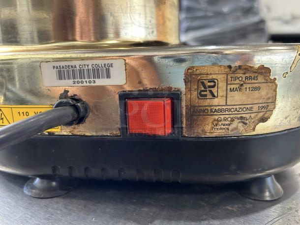 Gino Rossi RR45 espresso grinder with Pasadena City College label and 1997 manufacturing date; power switch visible.