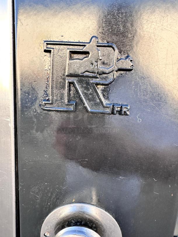 Rotisol RR-20 rotisserie oven logo close-up on black surface; part of oven's branding detail.